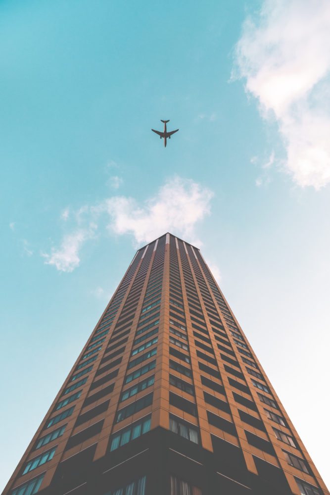 sky scraper from bottom to top with a plane