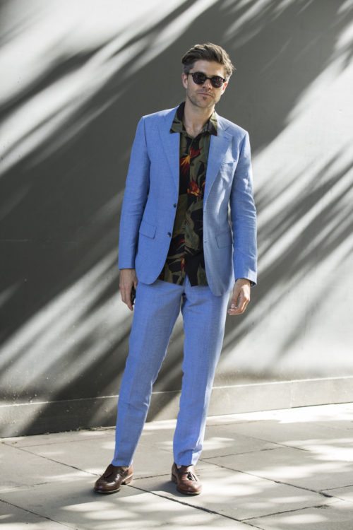Man in Blue suit and tropical shirt during London Fashion Week