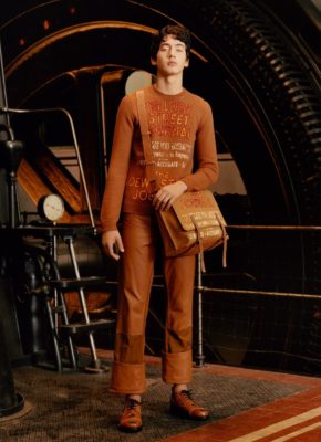 Male Model in Orange Sweater, orange leather trousers and bag