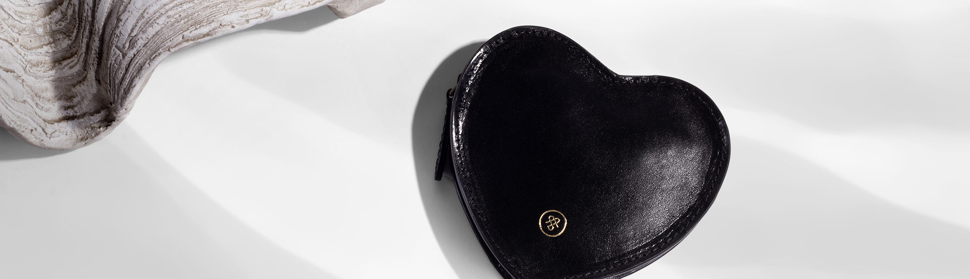 Black MirabellaL from Maxwell Scott next to a shell