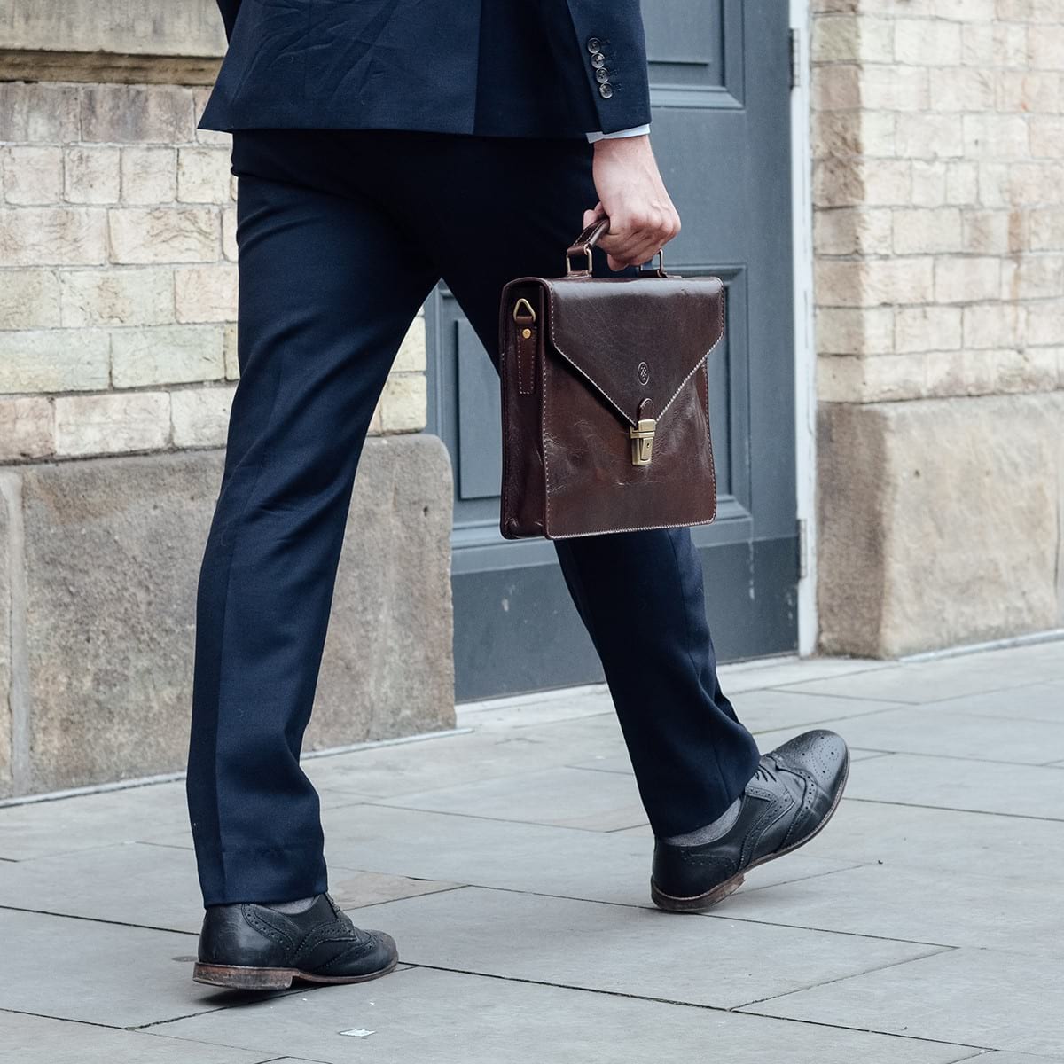 Men’s leather briefcase with tailored outfit