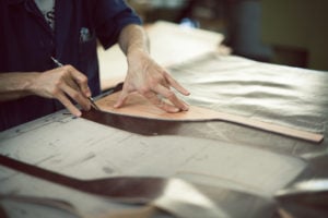 Leather Artisian working on producing a Maxwell Scott Bag