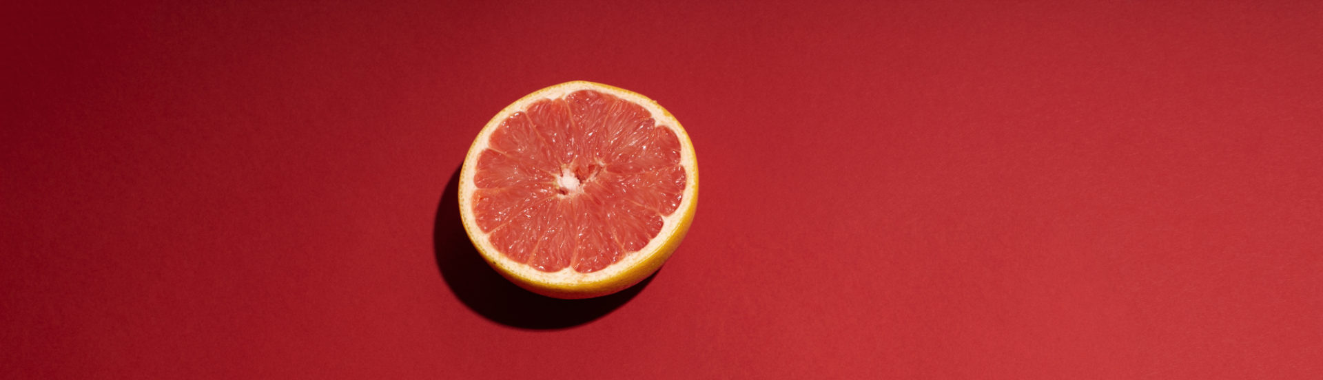 Grapefruit on red background