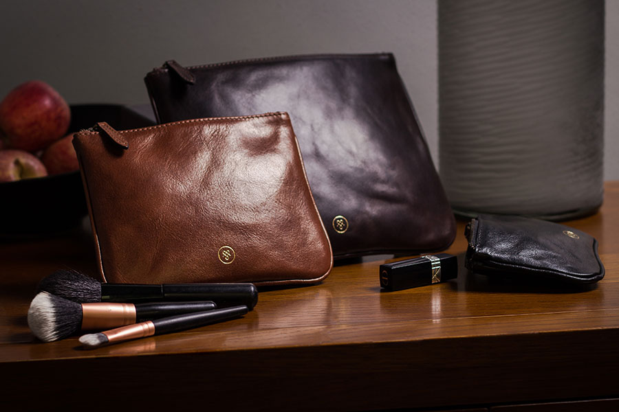 Makeup Bag Trio Sienna by Maxwell Scott on a night stand