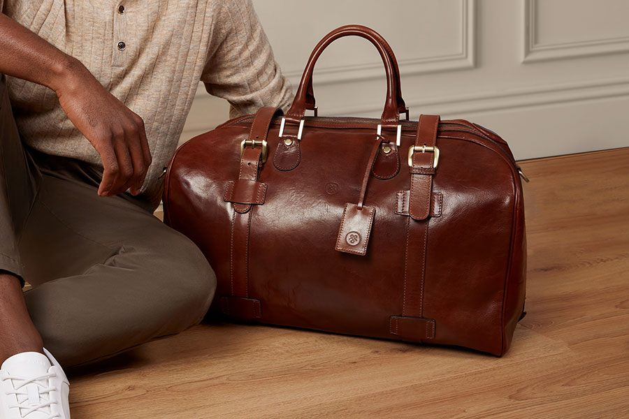 Man sitting next to FleroM luggage bag