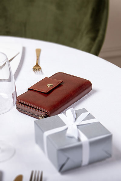 Tan Giorgia on White table next to gift