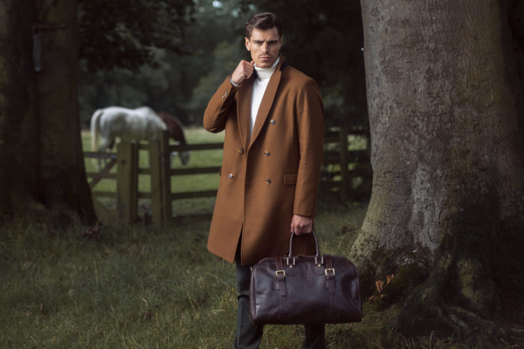 Man in nature with Tree and horse and leather holdall
