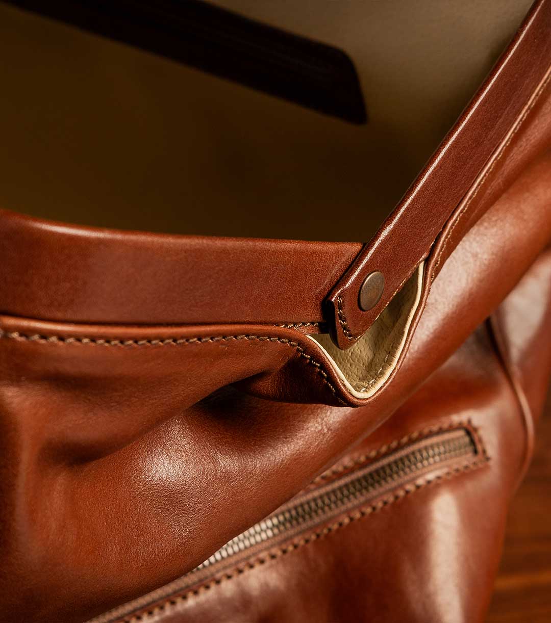 side shot of tan brown leather luggage