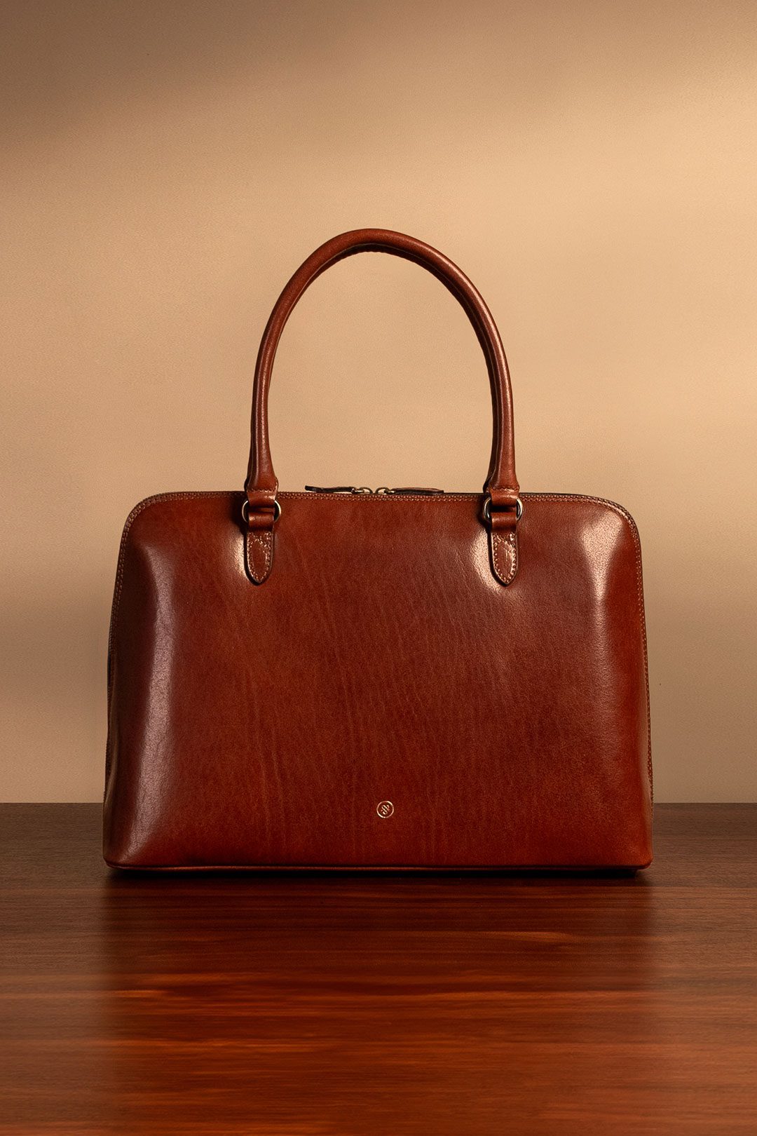 best leather business bag for women in tan brown sat on table