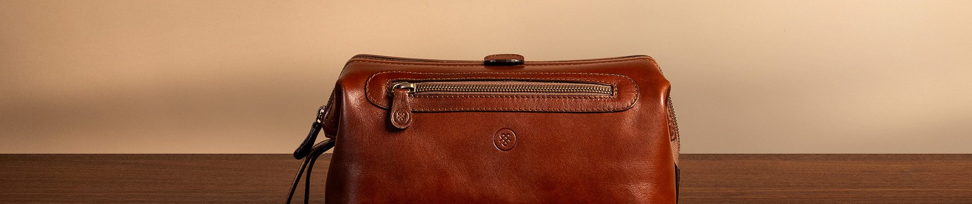 Leather travel wash bag with wide opening and secure zip closure