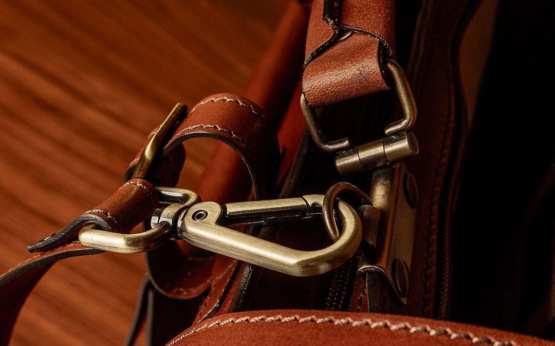 leather straps and brushed brass clasps